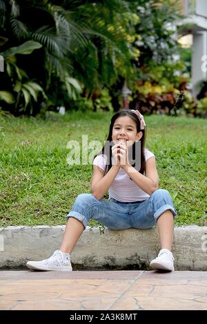 Young Filipina Tween Praying Stock Photo