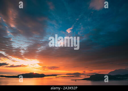 Alesund, Norway. Amazing Natural Bright Dramatic Sky In Warm Colours Above Alesund Valderoya And Islands In Sunset Sunrise Time. Colorful Sky Backgrou Stock Photo