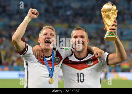 Bastian SCHWEINSTEIGER ends his career! Archiv photo: v.li: Bastian SCHWEINSTEIGER (GER), Lukas PODOLSKI (GER) with cup, jubilation, joy, enthusiasm, award ceremony, Cup, Trophy, Trophy. Germany (GER)) - Argentina (ARG) 1-0 nV Final, Final, Game 64, on 13.07.2014 in Rio de Janeiro. Football World Cup 2014 in Brazil from 12.06. - 13.07.2014. | Usage worldwide Stock Photo