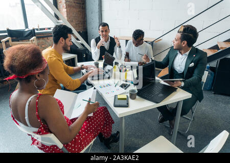 The discussion at the working meeting is led by a team of young entrepreneurs Stock Photo