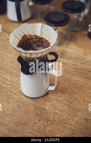 Alternative coffee. Funnel with filter and coffee over the pitcher Stock Photo