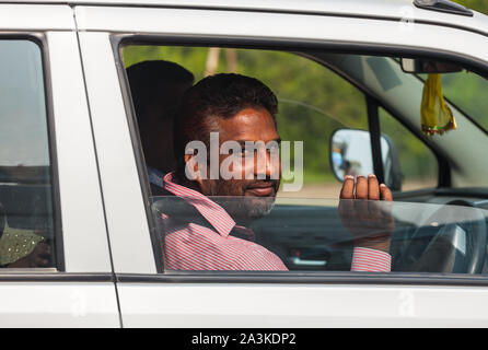 Indian man in car smiling Stock Photo