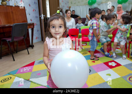 Birthday two years in the kindergarden . Children's birthday with animators . Happy group of children at a birthday celebration dressed in the style Stock Photo