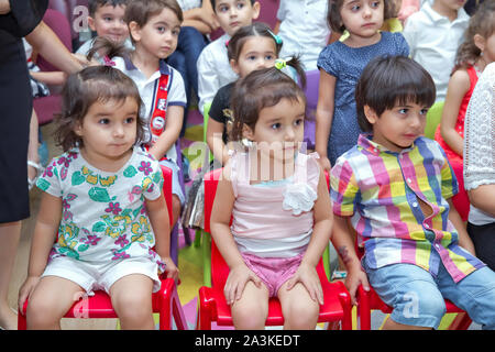 Birthday two years in the kindergarden . Children's birthday with animators . Happy group of children at a birthday celebration dressed in the style Stock Photo