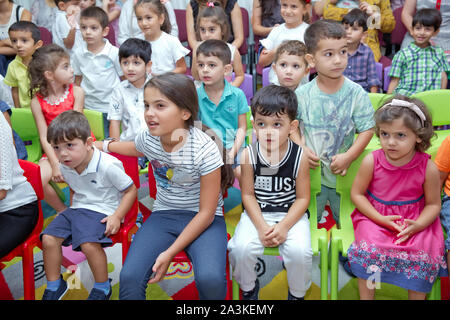 Birthday two years in the kindergarden . Children's birthday with animators . Happy group of children at a birthday celebration dressed in the style Stock Photo