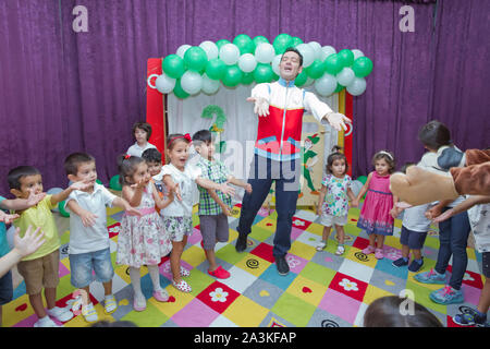 Birthday two years in the kindergarden . Children's birthday with animators . Happy group of children at a birthday celebration dressed in the style Stock Photo