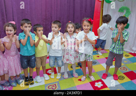 Birthday two years in the kindergarden . Children's birthday with animators . Happy group of children at a birthday celebration dressed in the style Stock Photo