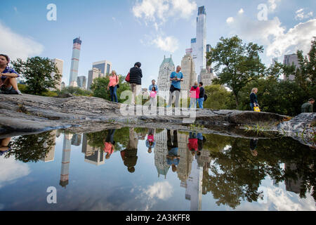 Billionaires' Row. The tall building to the left is 432 Park Avenue condominium and office tower on Manhattan. The tall building to the right is One 57th Street (behind Essex). The towers are two of an increasing number of expensive luxury condo towers near Central park. Stock Photo