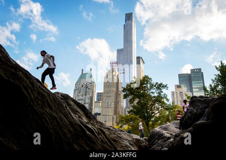 One 57th condominium and office tower as seen from Central Park on Manhattan. The tower is one of an increasing number of expensive luxury condo towers near Central park. Stock Photo