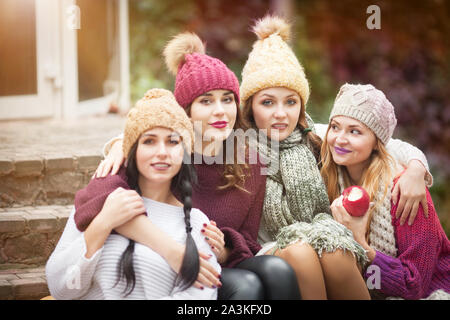 Women are best friends with fruit on a picnic in the countryside. Outdoors lifestyle fashion portrait. Positive emotions. Stock Photo