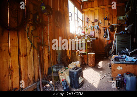 Workshop, shed, garage or storage room with tools for repair, chores, spare parts from various equipment Stock Photo