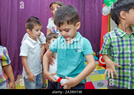 Birthday two years in the kindergarden . Children's birthday with animators . Happy group of children at a birthday celebration dressed in the style Stock Photo