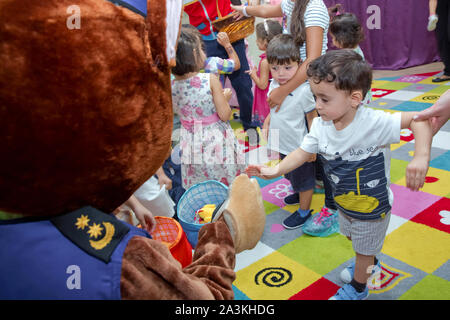 Birthday two years in the kindergarden . Children's birthday with animators . Happy group of children at a birthday celebration dressed in the style Stock Photo