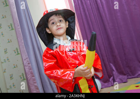 Birthday two years in the kindergarden . Children wearing fire extinguishers . Expressive cute toddler boy with fireman's outfit on Stock Photo