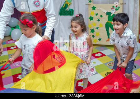 Birthday two years in the kindergarden . Children's birthday with animators . Happy group of children at a birthday celebration dressed in the style Stock Photo