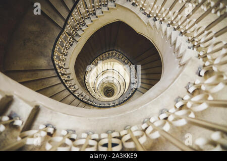 Very deep descending spiral staircase Stock Photo