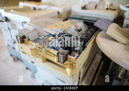Shallow depth of field image with electronic and mechanical components of an old multifunction printer Stock Photo