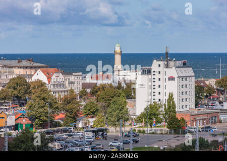The lighthouse on the coast looking over the rooftops of Warmemunde, Rostock, Germany. Stock Photo