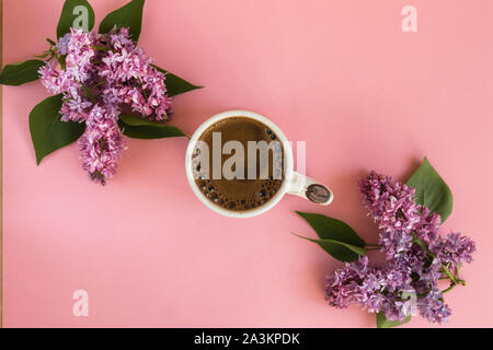 Violet cup of morning coffee or cappuccino and delicate purple, lilac  flowers. Mother's day concept. Cozy breakfast Stock Photo - Alamy