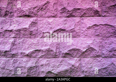 Texture of rough brick painted purple wall. Vintage violet brick background. Stock Photo