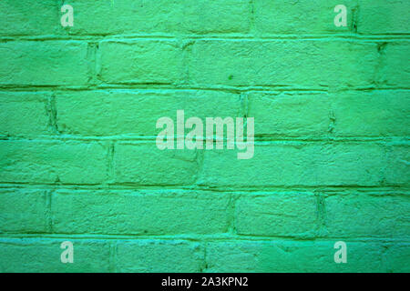 Texture of brick painted green wall. Stone old architecture background. Stock Photo