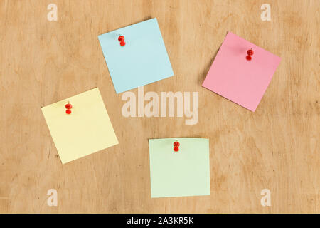 Colorful stickers pin on the wooden board. Mockup for office design. Stock Photo