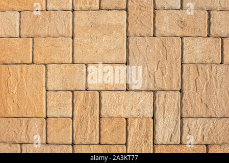 Highly detailed street pavement background with geometric pattern made of square blocks of different sizes with textured rough surface in brown and be Stock Photo