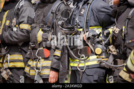 Several standing firefighters in special suits and gas masks, close-up Stock Photo