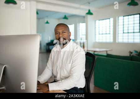 African American businessman using a computer at his office desk Stock Photo