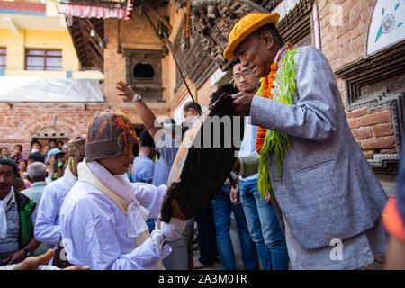 Bhaktapur, Nepal. 09th Oct, 2019. A man attired as a warrior hand overs an ancient sword and shield during Khadga Jatra in Thimi, Nepal on October 9, 2019. (Photo by Rojan Shrestha/Pacific Press) Credit: Pacific Press Agency/Alamy Live News Stock Photo