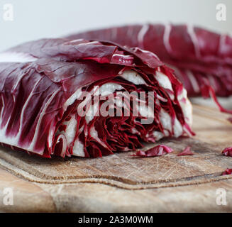 Raw red chicory on a wooden board close up Stock Photo