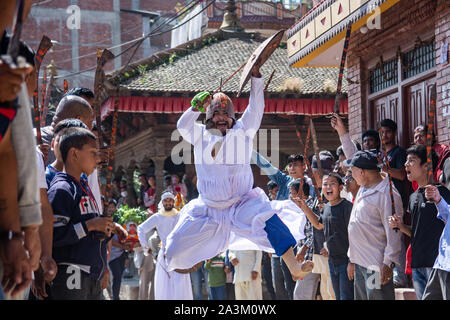 Bhaktapur, Nepal. 09th Oct, 2019. A man attired as a warrior jumps in air with an ancient sword during a traditional ritual dance on Khadga Jatra in Thimi, Nepal on October 9, 2019. (Photo by Rojan Shrestha/Pacific Press) Credit: Pacific Press Agency/Alamy Live News Stock Photo