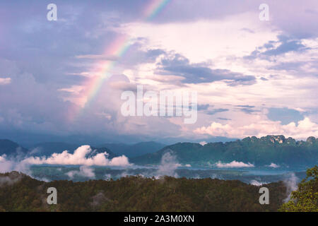 Landscape with rainbows and clouds background. Stock Photo