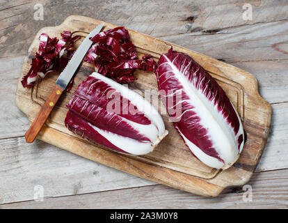 Raw red chicory on a wooden board close up Stock Photo