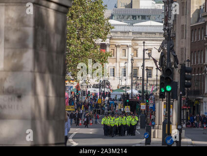 Whitehall, London, UK. 9th October 2019. Large police presence makes arrests and removes Extinction Rebellion activists from Whitehall. Additional police officers arrive from Trafalgar Square. Credit: Malcolm Park/Alamy Live News.