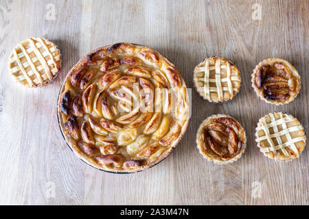 Homemade apple pies on a wooden table in a kitchen Stock Photo