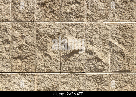 Beige granit or marble natural tile on wall of exterior. Grunge, stone texture, for background. Stock Photo
