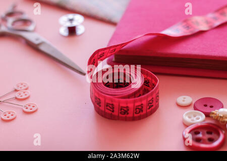 https://l450v.alamy.com/450v/2a3m62w/measure-tape-in-pink-color-with-other-sewing-objects-2a3m62w.jpg