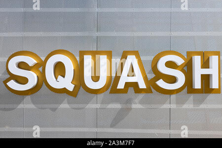 Minsk, Belarus - July, 2019. Word Squash made of big white and dark beige color letters on white metal surface with a lot of tiny round openings Stock Photo