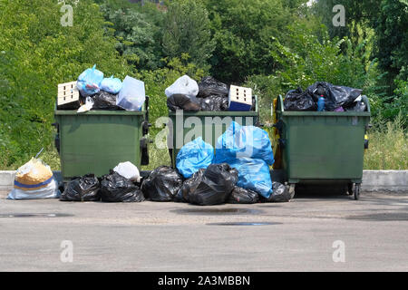 Dumpsters being full with garbage. Garbage is pile lots dump. Garbage waste lots junk dump. Stock Photo
