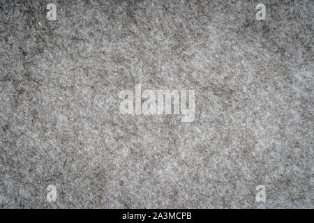 Grey heather knitted fabric made of synthetic fibres textured background. Grey knitted fabric texture. Background with delicate striped pattern, close Stock Photo