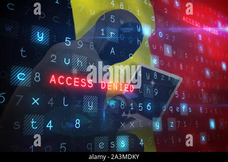 Composite image of hacker using laptop Stock Photo