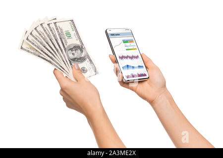 Trading app opened on smartphone and cash in female hands Stock Photo