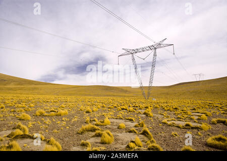 Power lines towers in the Altiplano (high Andean plateau) at 4200 meters over the sea level, Atacama desert, Antofagasta Region, Chile, South America Stock Photo