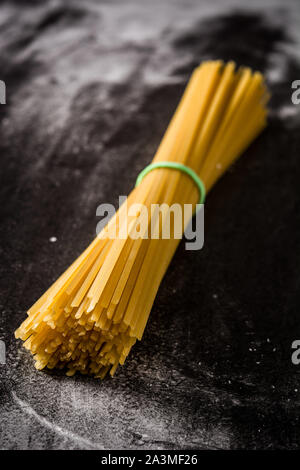 Raw spaghetti on black background Stock Photo