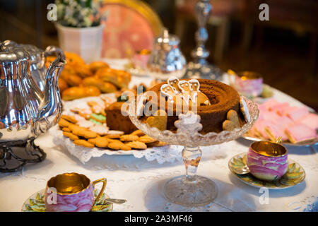 Beautiful Christmas classic table setting with traditional Finnish treats. Tea set, coffee pot and pastries. Stock Photo