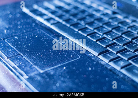 Close up of an old dusty laptop keyboard. Unhygienic equipment in home or office. Stock Photo