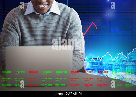 Composite image of smiling businessman using laptop at desk Stock Photo