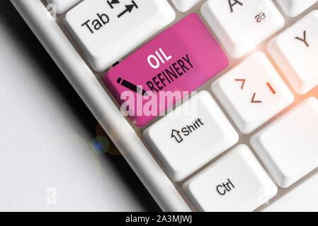 Handwriting text Oil Refinery. Conceptual photo industrial process of converting crude oil into petroleum White pc keyboard with empty note paper abov Stock Photo