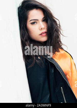 beautiful young Spanish woman wearing black leather jacket Stock Photo